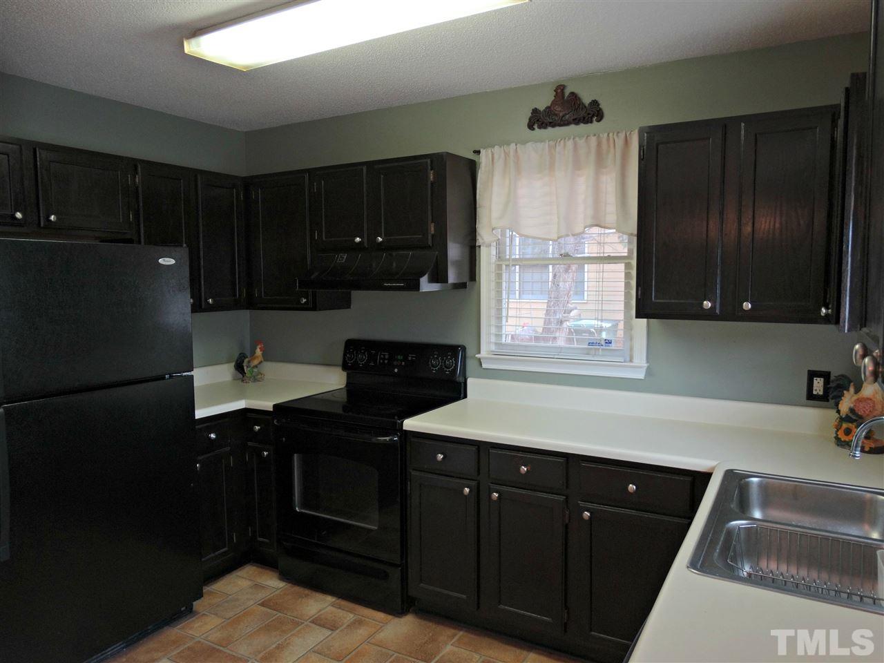 109 Longneedle Court Raleigh, NC 27603 - Photo 13 of 23 a kitchen with a sink and a refrigerator