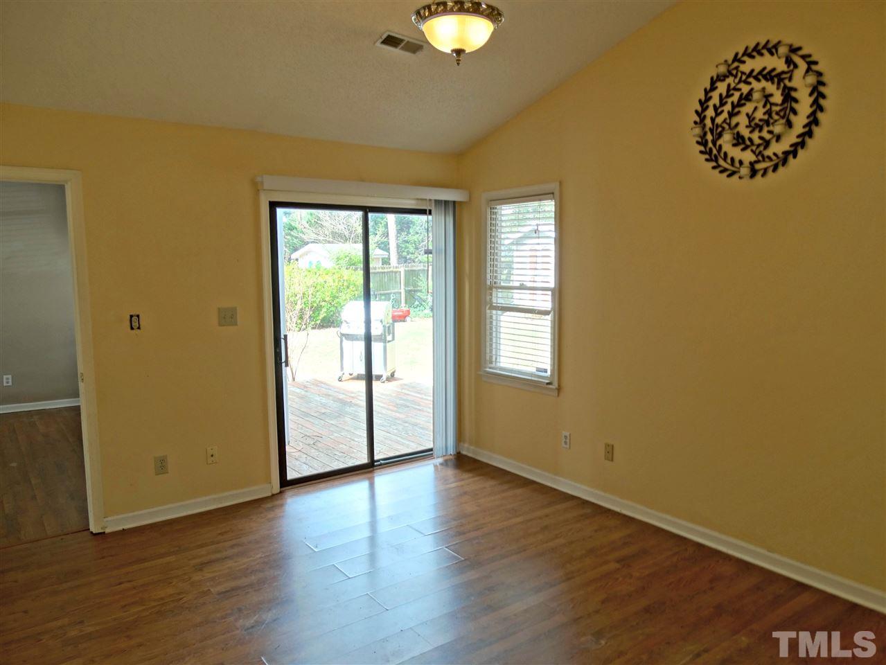 109 Longneedle Court Raleigh, NC 27603 - Photo 16 of 23 a view of an empty room with wooden floor and a window