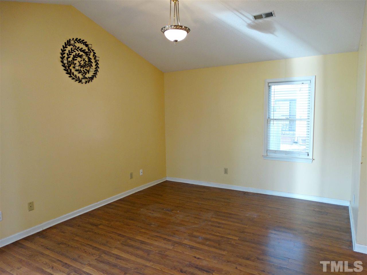 109 Longneedle Court Raleigh, NC 27603 - Photo 17 of 23 an empty room with wooden floor and windows