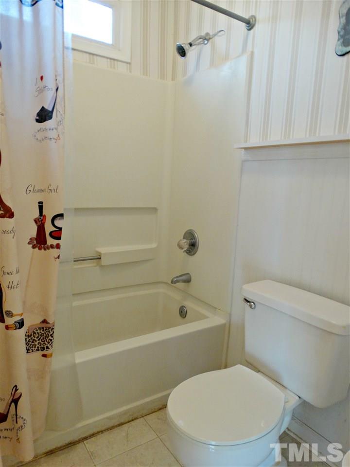 109 Longneedle Court Raleigh, NC 27603 - Photo 18 of 23 a white toilet and tub sitting next to a bathroom sink