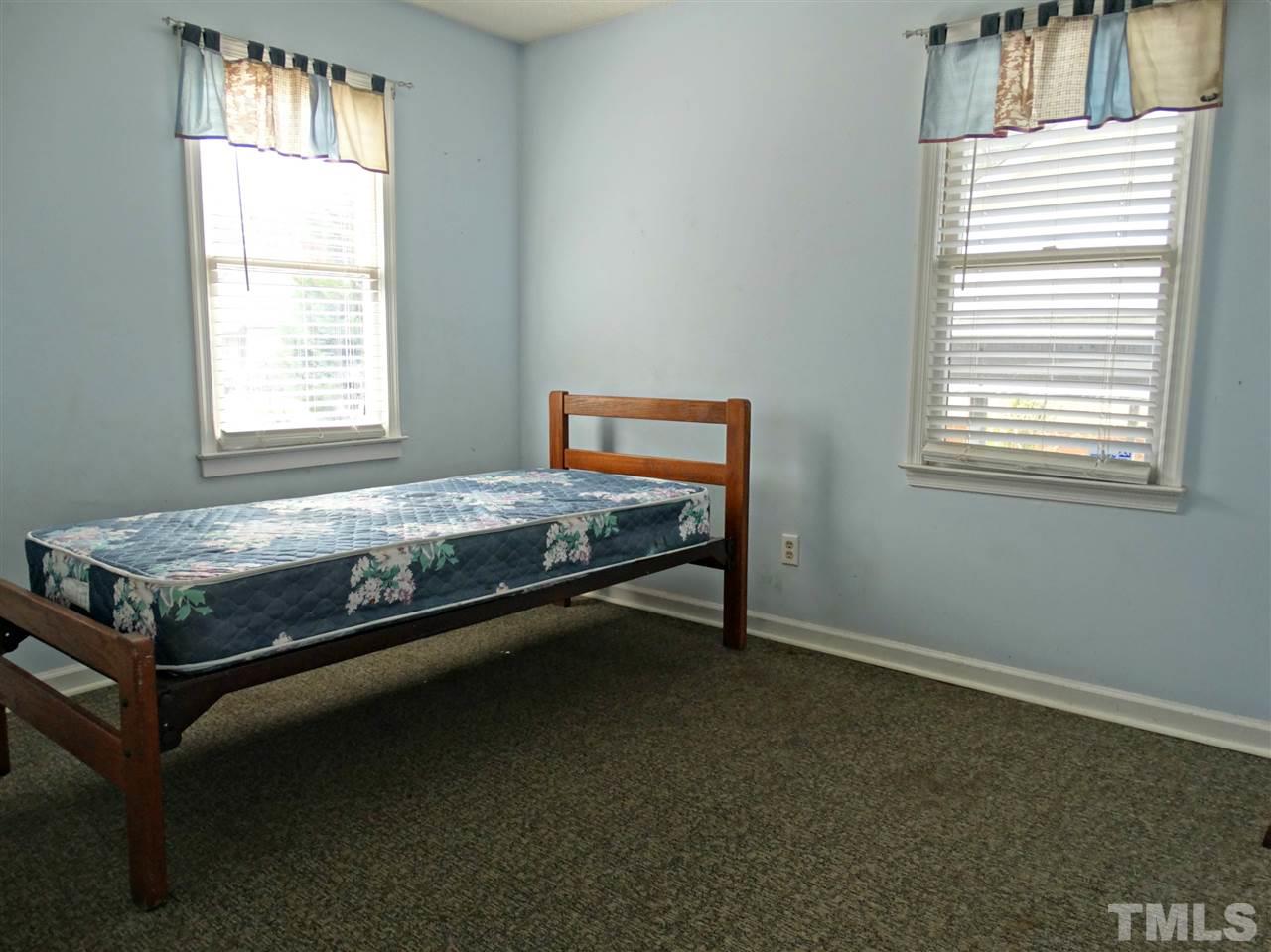109 Longneedle Court Raleigh, NC 27603 - Photo 19 of 23 a bed sitting in a bedroom next to a window
