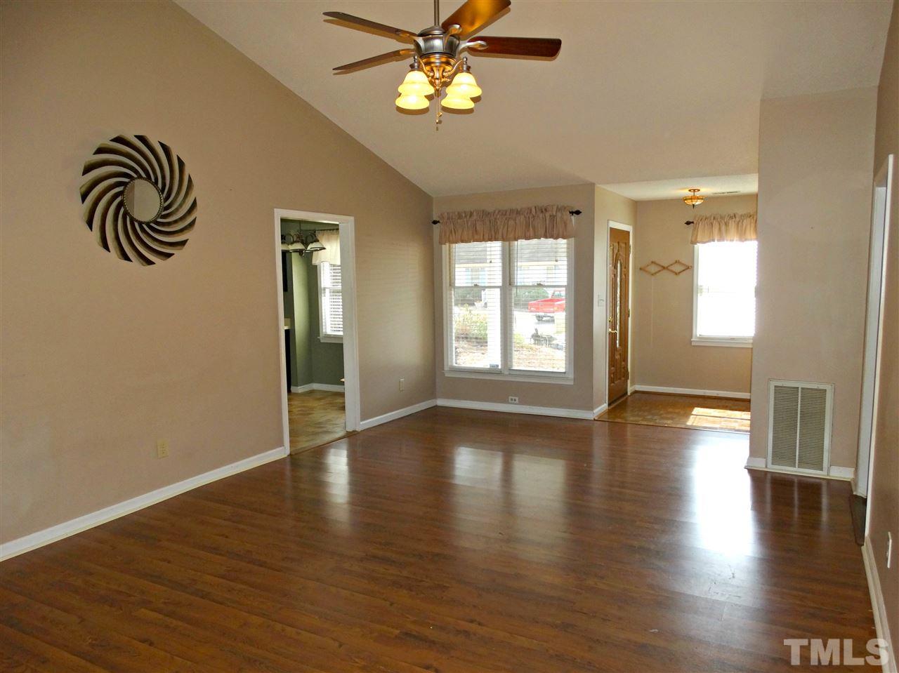 109 Longneedle Court Raleigh, NC 27603 - Photo 7 of 23 a view of empty room with wooden floor and fan