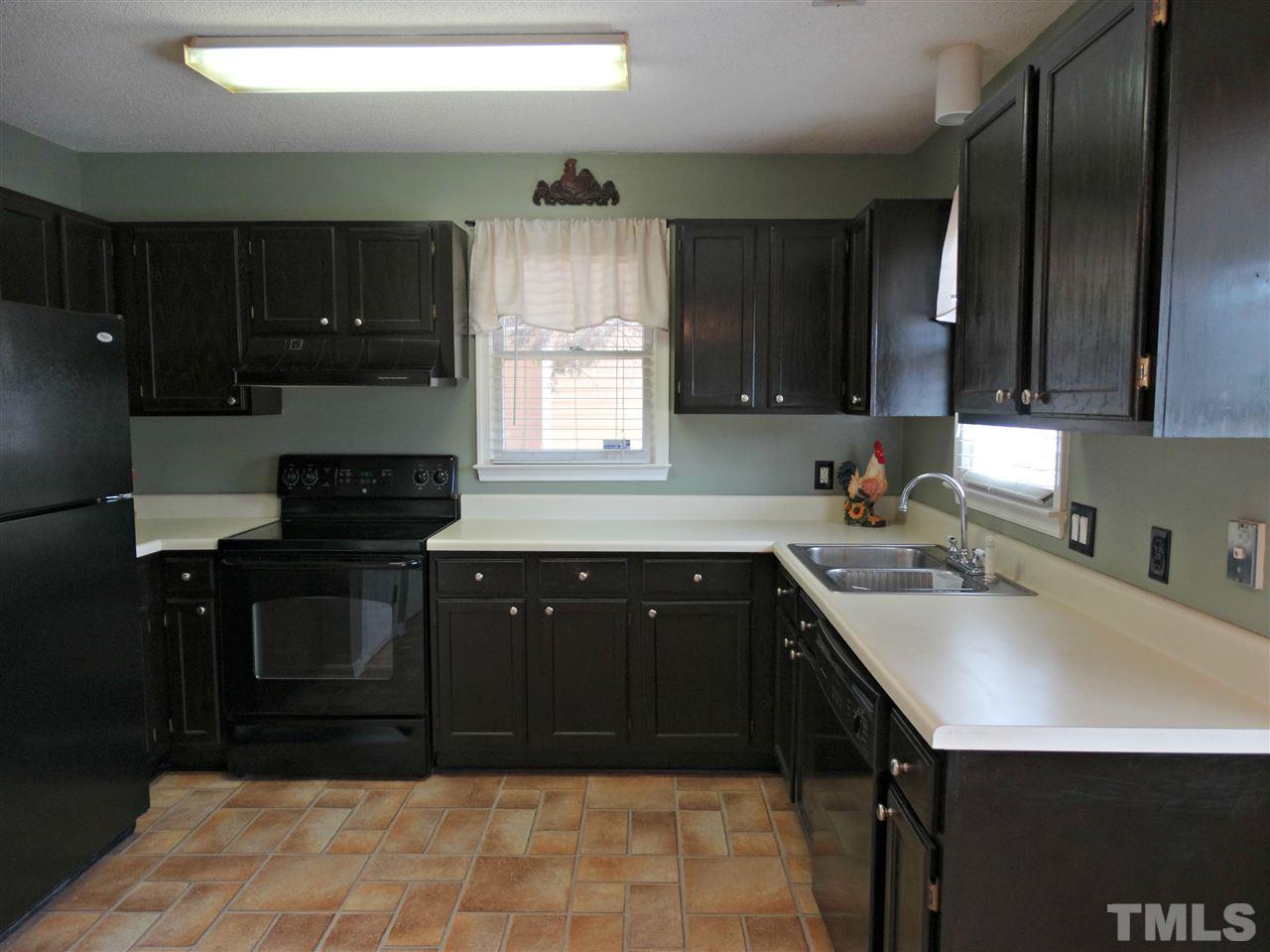 109 Longneedle Court Raleigh, NC 27603 - Photo 9 of 23 a kitchen with a sink a stove and cabinets