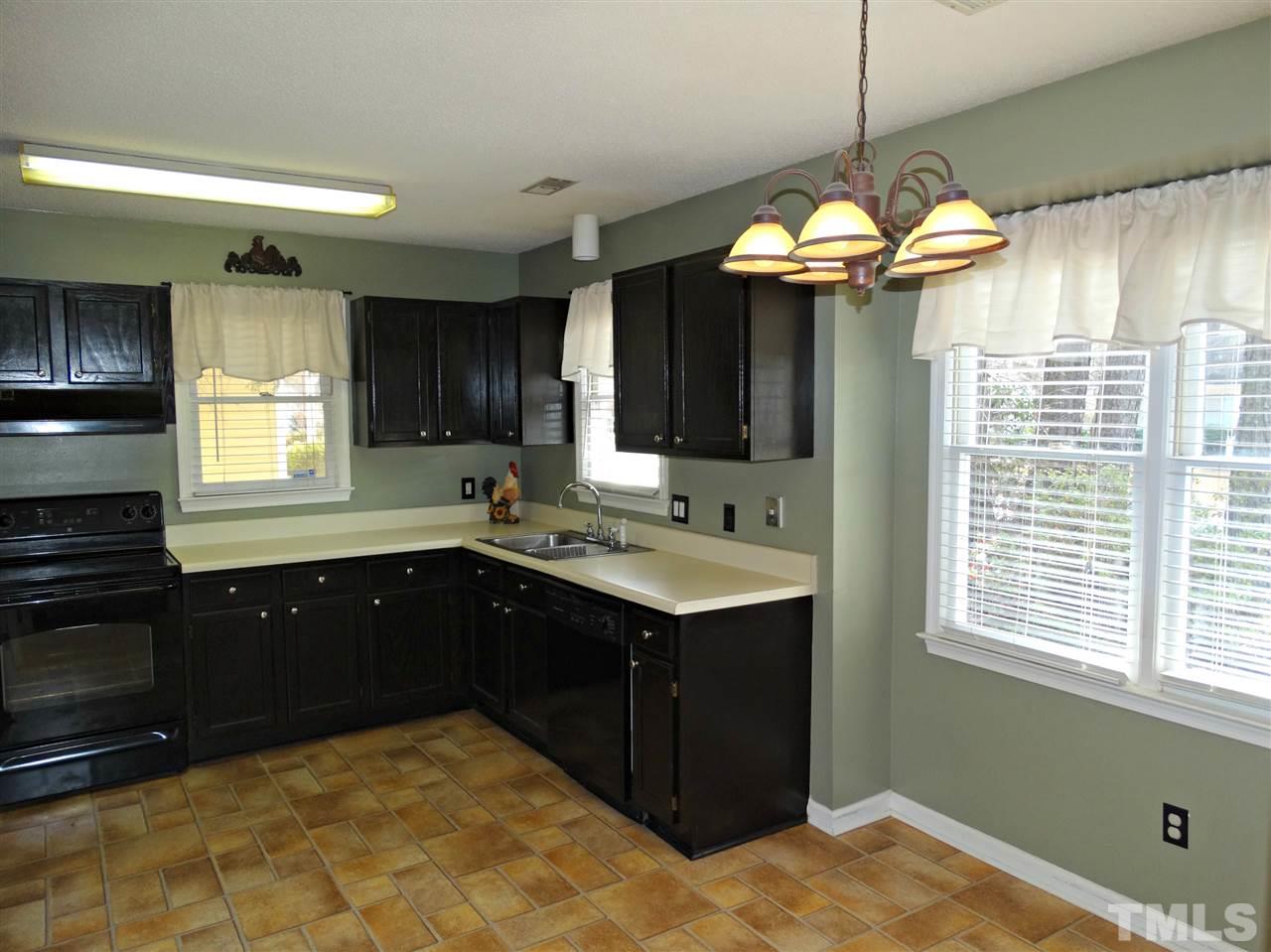 109 Longneedle Court Raleigh, NC 27603 - Photo 10 of 23 a kitchen with a stove a sink and a window