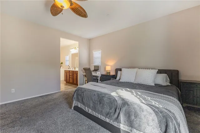a spacious bedroom with a bed and a chandelier