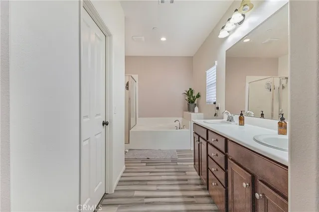 a spacious bathroom with a double vanity sink and a mirror