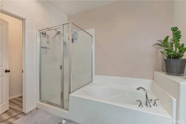 a bathroom with a tub and shower