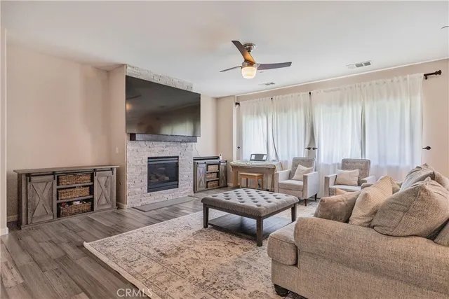 a living room with furniture flat screen tv and a fireplace