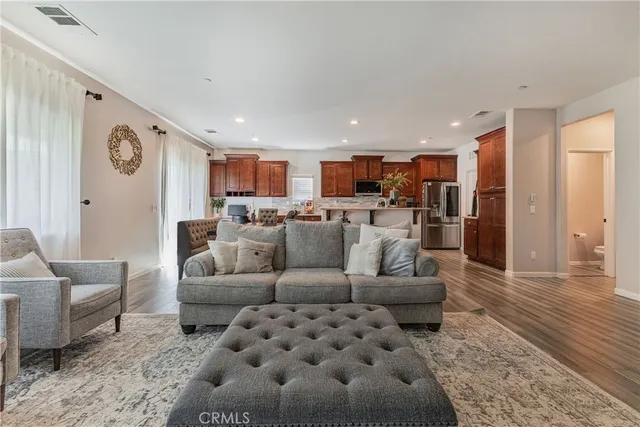 a living room with furniture and kitchen view