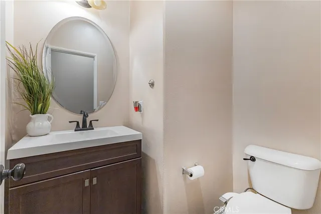 a bathroom with a sink toilet and mirror
