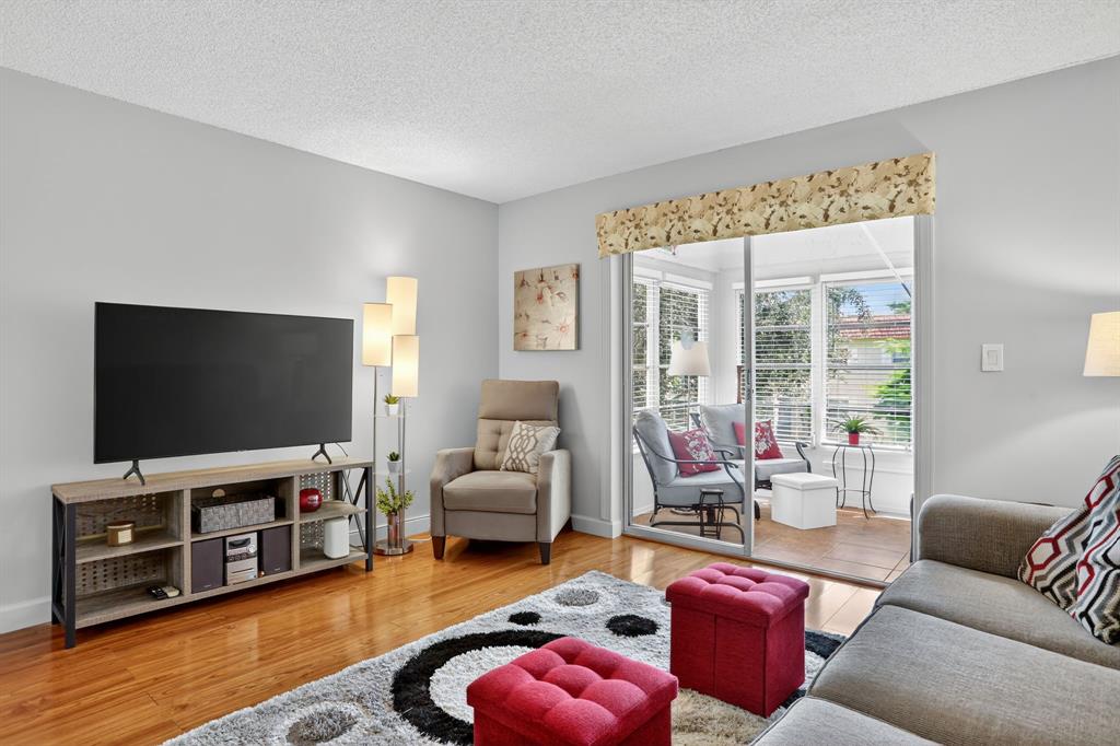 5640 Southwest 3rd Place, Unit 208 Margate, FL 33068 - Photo 11 of 26 a living room with furniture and a flat screen tv