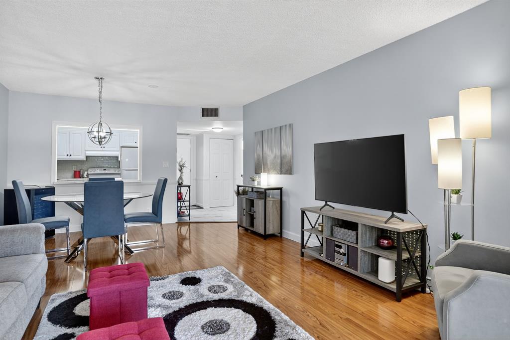 5640 Southwest 3rd Place, Unit 208 Margate, FL 33068 - Photo 12 of 26 a living room with furniture and a flat screen tv