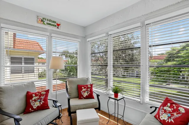 a living room filled with furniture and a large window