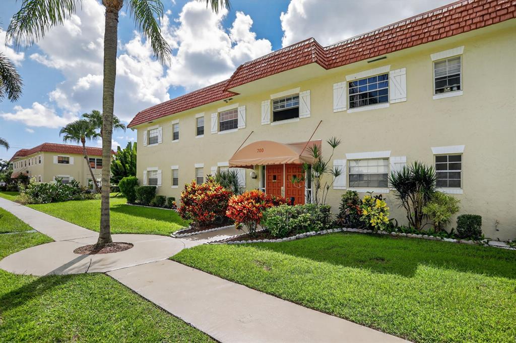 5640 Southwest 3rd Place, Unit 208 Margate, FL 33068 - Photo 24 of 26 a front view of a house with a garden and plants