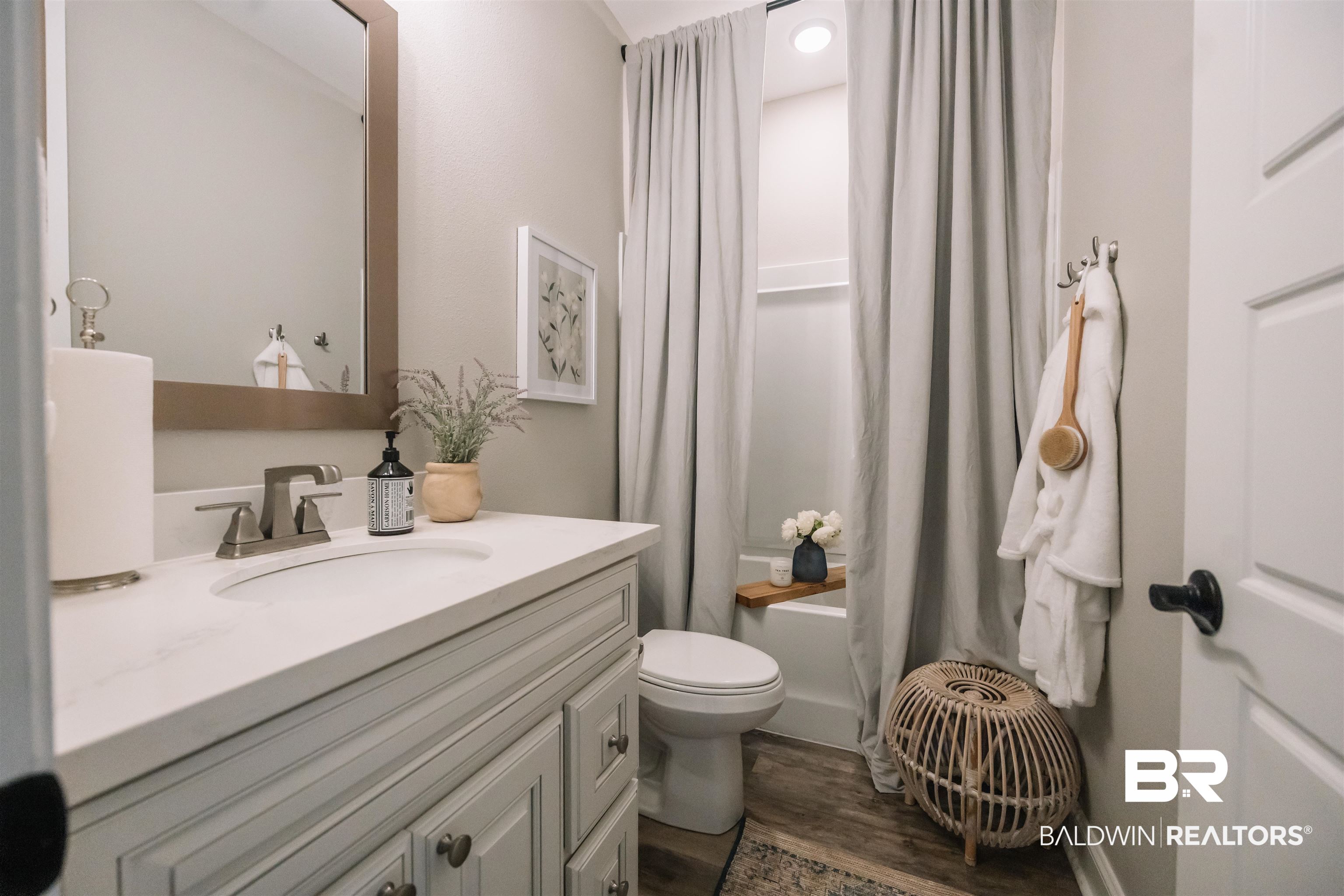 12894 Flanagan Street Elberta, AL 36530 - Photo 4 of 29 Full bathroom featuring shower / bath combo with shower curtain, hardwood / wood-style flooring, vanity, and toilet