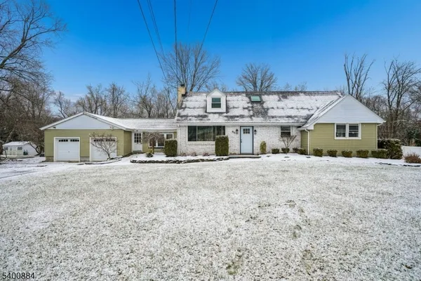 a view of house with outdoor space and tall tree