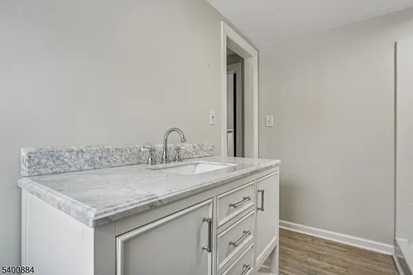 a utility room with cabinets and sink