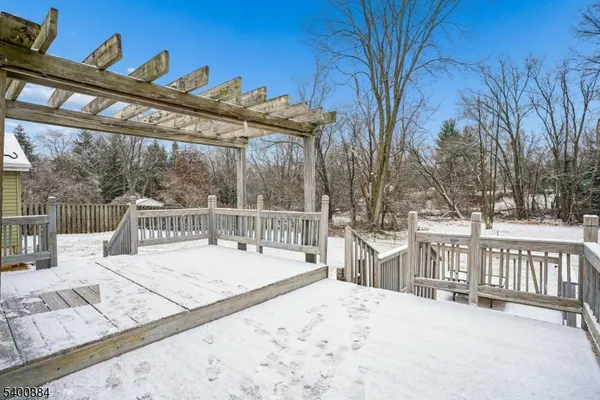 a view of a house with a wooden deck
