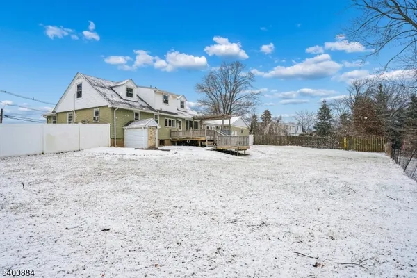 a view of large house with a snow in the yard