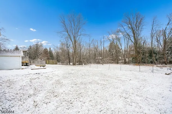 a view of a yard with snow on the road