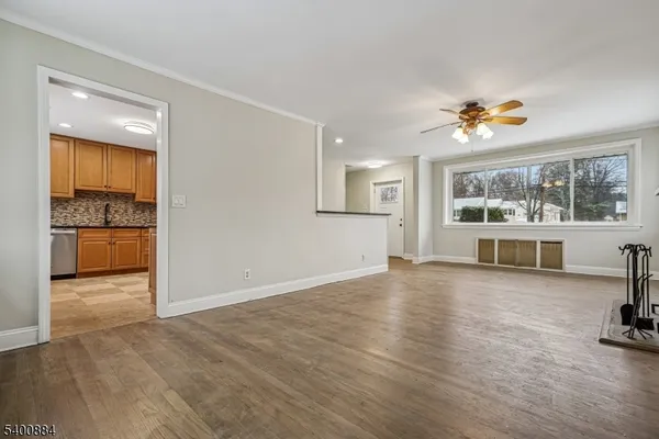 an empty room with windows and chandelier