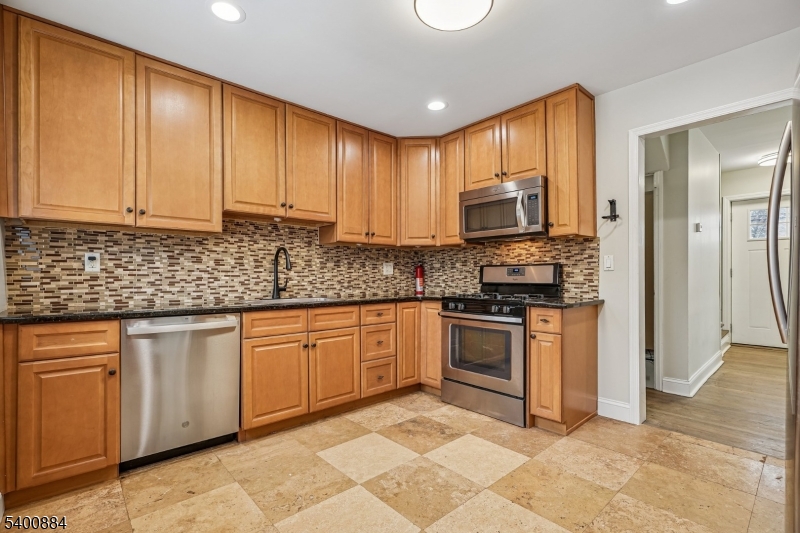 68 Valley Road Hillsborough, NJ 08844 - Photo 9 of 38 a kitchen with stainless steel appliances granite countertop a stove top oven a sink and dishwasher