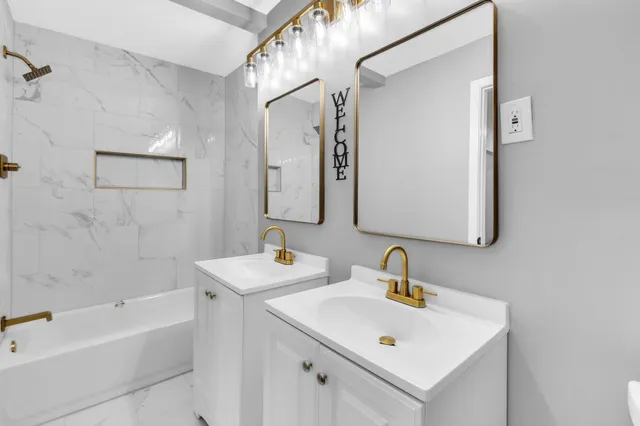 a bathroom with a sink a mirror and a bathtub