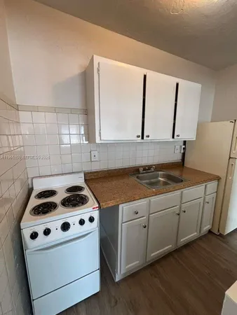 a view of kitchen with a sink and wooden floor