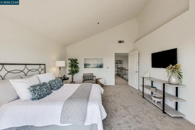 a spacious bathroom with a double vanity sink a large mirror and a bathtub