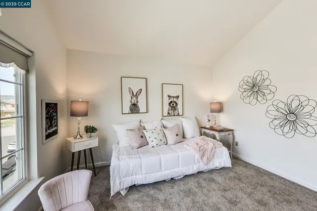 a living room with furniture a window and a potted plant