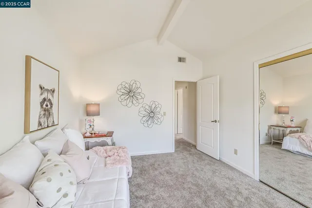 a bathroom with a granite countertop sink mirror vanity and toilet