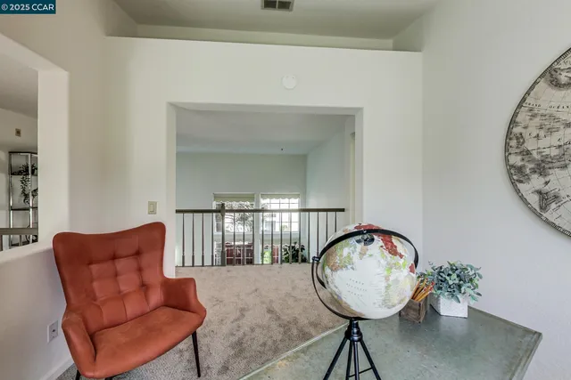 a view of a dining room with furniture and a window