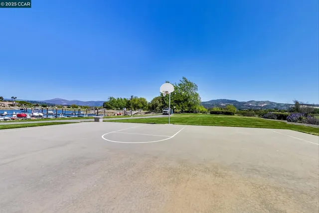 a view of a lake with boats and trees in the background