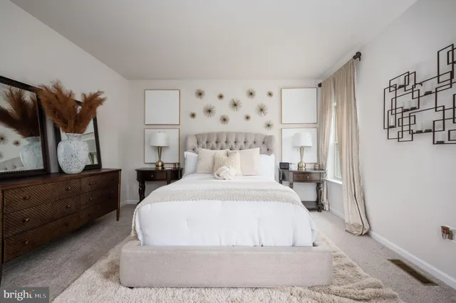 a large white bed in a white room