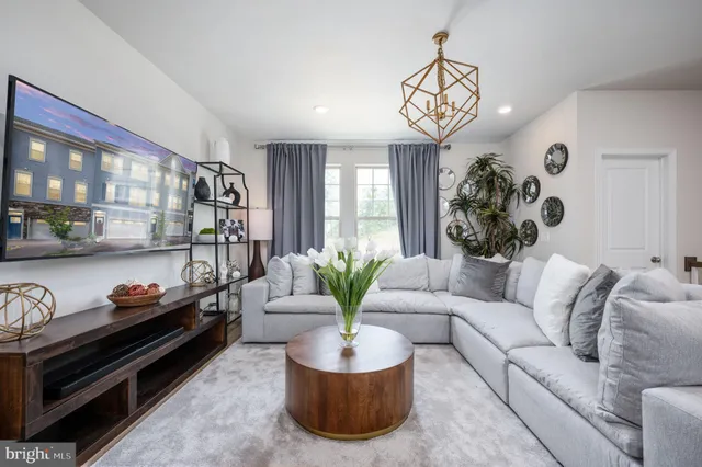 a living room with furniture and a chandelier