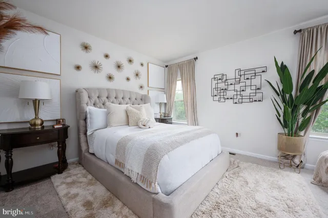 a bedroom with bed and a potted plant