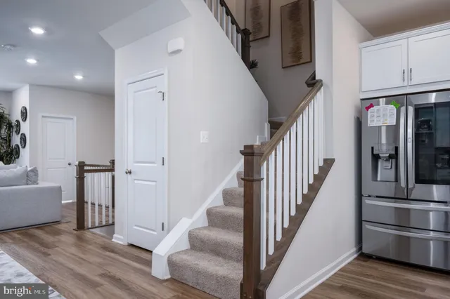 a view of entryway and hall with wooden floor