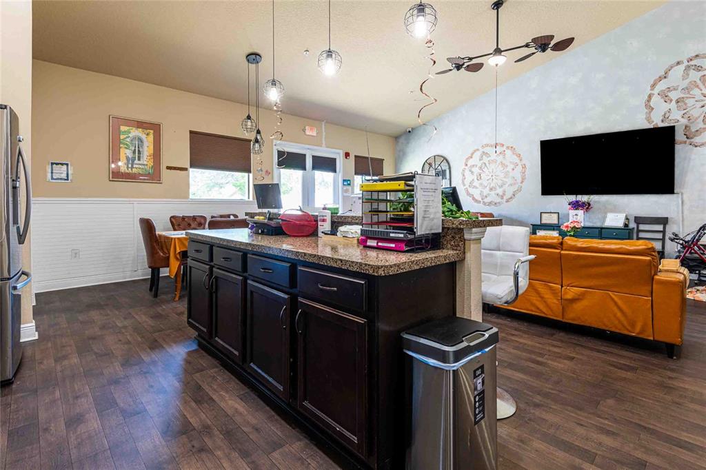Undisclosed Address Spring Hill, FL 34608 - Photo 13 of 39 a kitchen with stainless steel appliances a stove top oven and a refrigerator