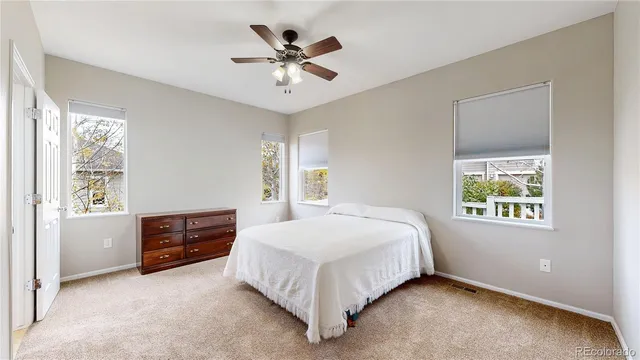 an empty room with closet and a chandelier fan