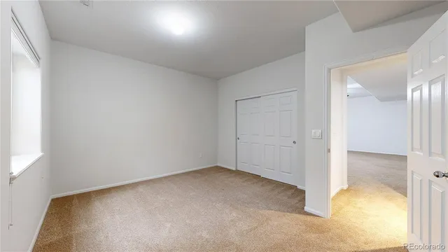 an aerial view of a house with swimming pool and large trees