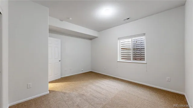 a front view of a house with plants