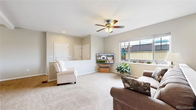 a view of a dining room with furniture and a chandelier