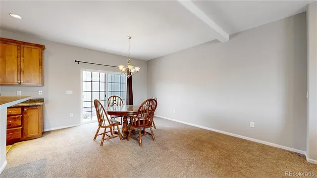 a kitchen with stove and chairs