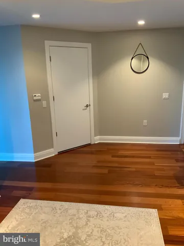 a view of a room with wooden floor and glass door