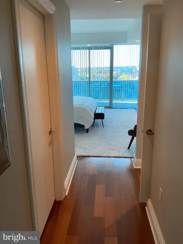 an empty room with wooden floor and sliding glass door