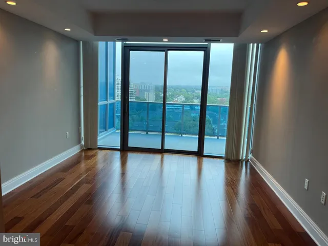 a living room with patio furniture and a potted plant