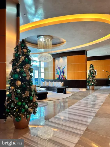 a lobby with furniture and potted plants