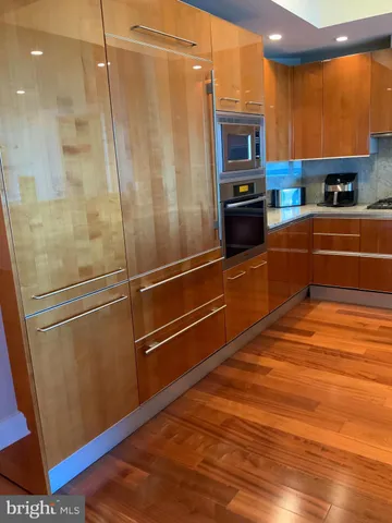 a kitchen with stainless steel appliances a refrigerator and a stove top oven