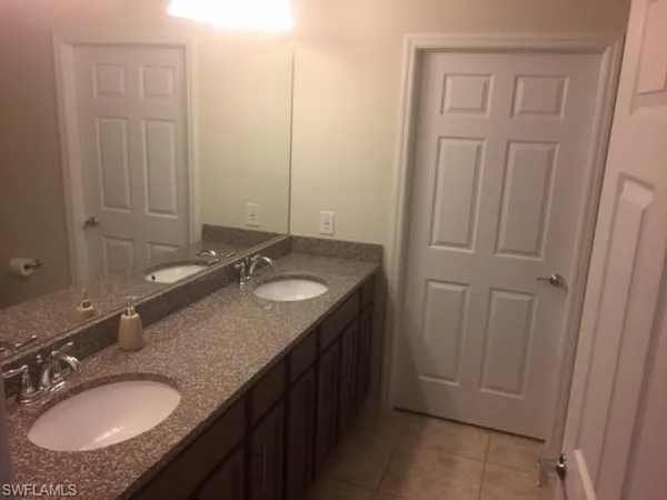 a bathroom with 2 sink and a mirror