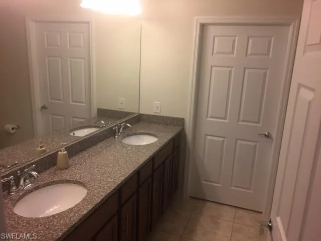 a bathroom with 2 sink and a mirror